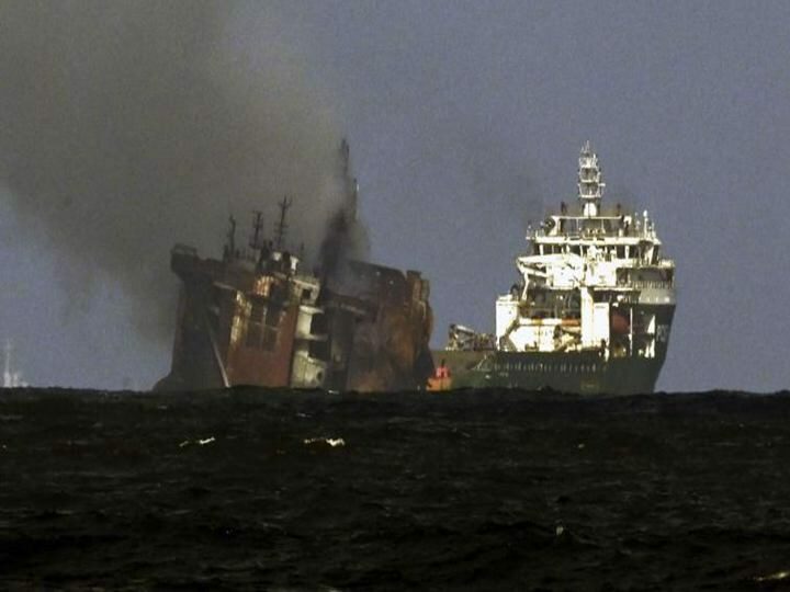 the charred body of the container ship ang its stern submerged in the water 1